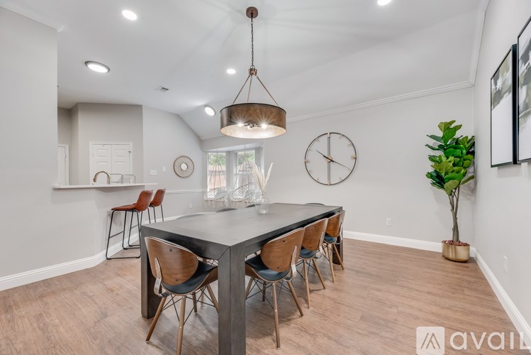 A dining room with a table and chairs.