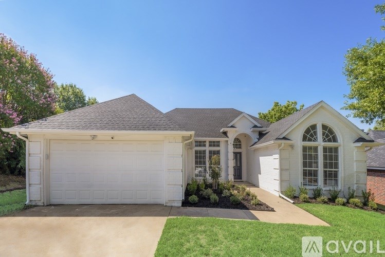 A house with a white garage door is for sale.