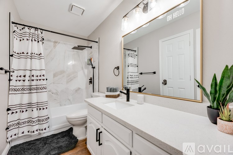 A bathroom with a white shower curtain and a white door.