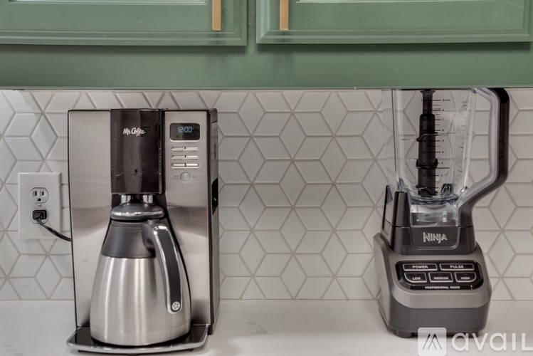 A Nespresso coffee maker and a Ninja blender on a kitchen counter.