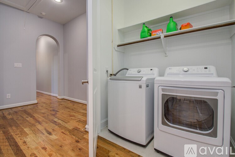 A kitchen with a white oven and a white washing machine.