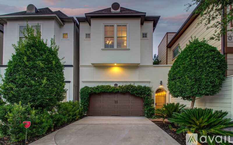 A house with a garage and a driveway is available for sale.