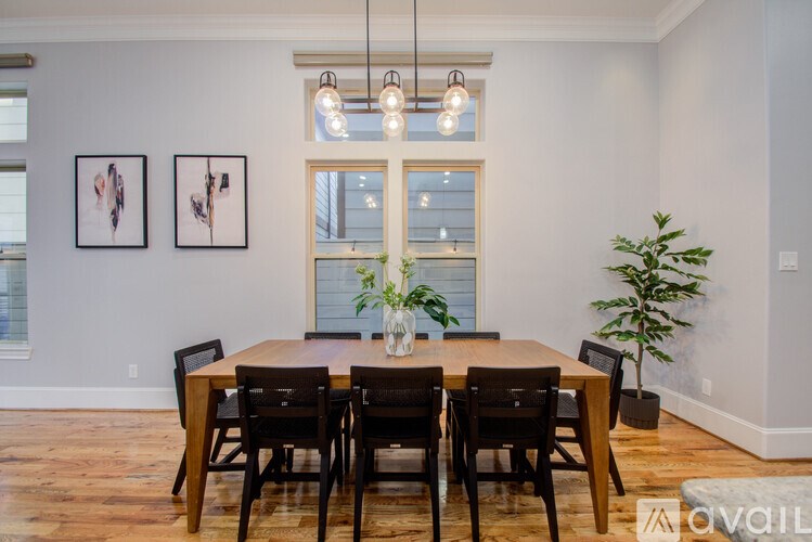 A dining room with a wooden table and chairs.