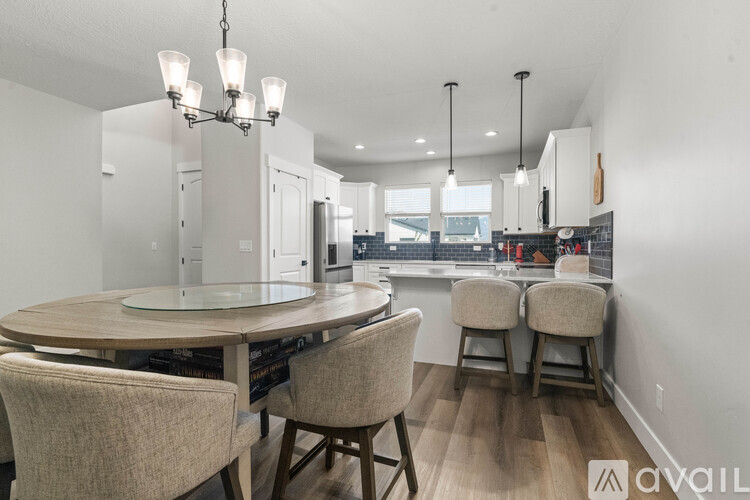 A modern dining room with a round table and chairs.