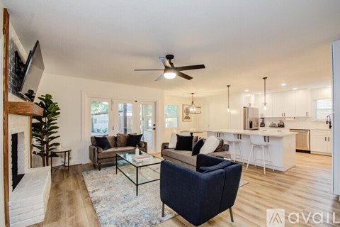 A living room with a dark blue sofa and a glass coffee table.