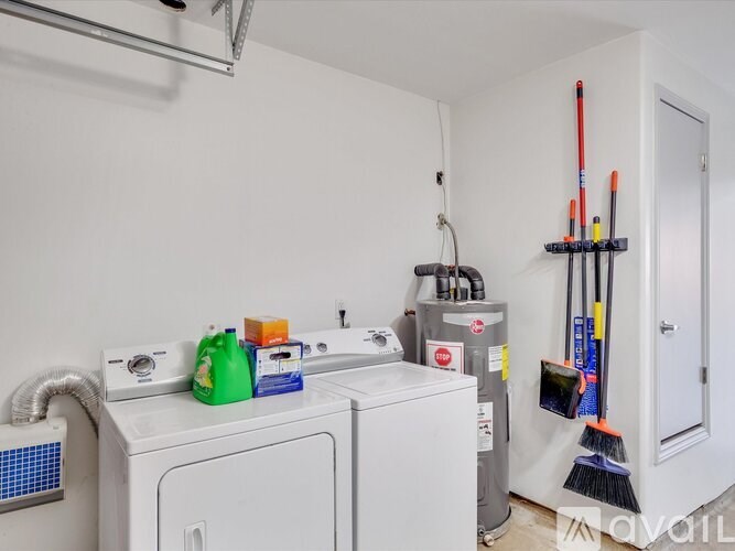 A white washing machine and dryer in a small laundry room.