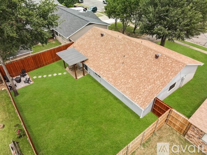 A house with a red roof and a white fence.