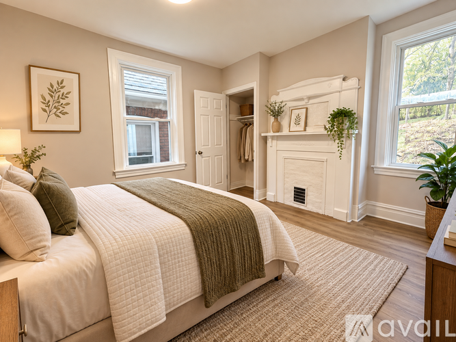 A bedroom with a large bed and a window.