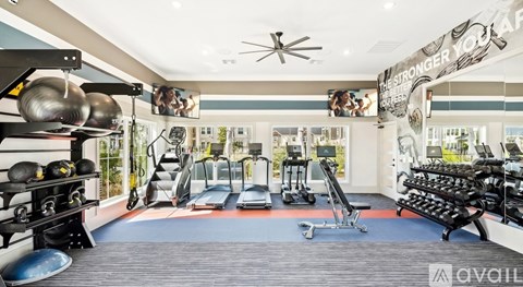 A gym with a variety of equipment including weights and cardio machines.