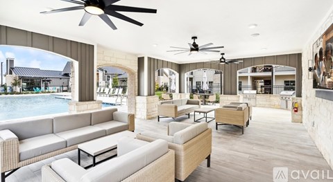 A spacious outdoor living area with a pool and furniture.