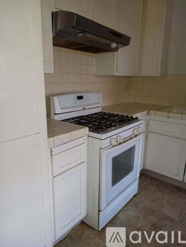 A white kitchen with a stove and oven.