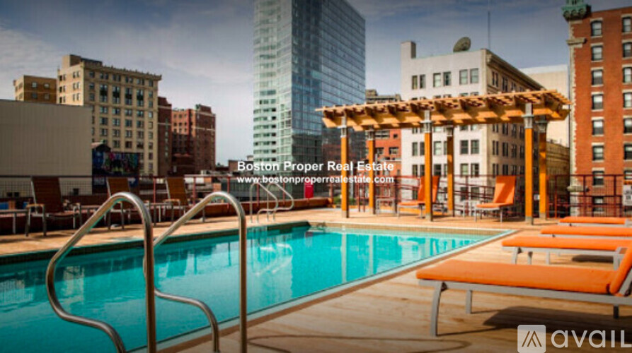 A pool area with a wooden pergola and lounge chairs is available for rent.