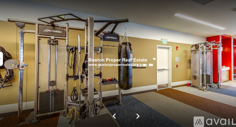 A gym with a variety of equipment including a punching bag.
