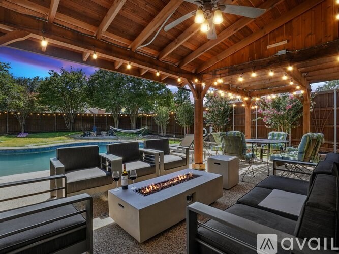 A patio with a fire pit and seating area.