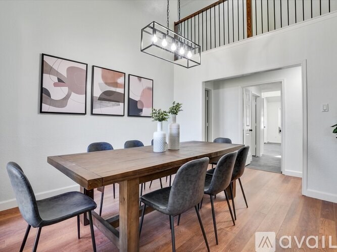 A dining room with a wooden table and chairs.