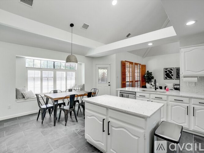 A modern kitchen with a dining table and chairs.