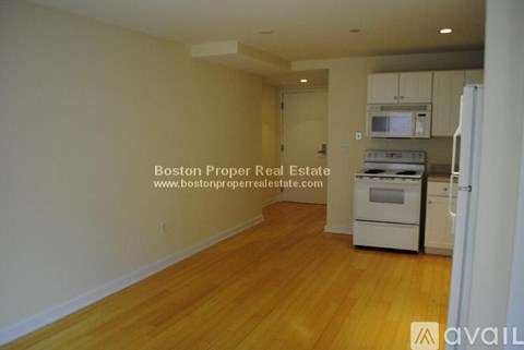 A kitchen area with a stove top oven and microwave.