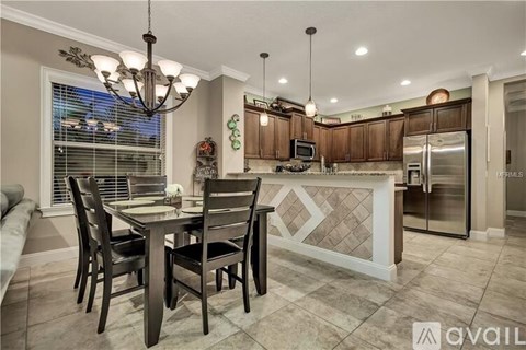 A modern kitchen with a dining table and chairs.