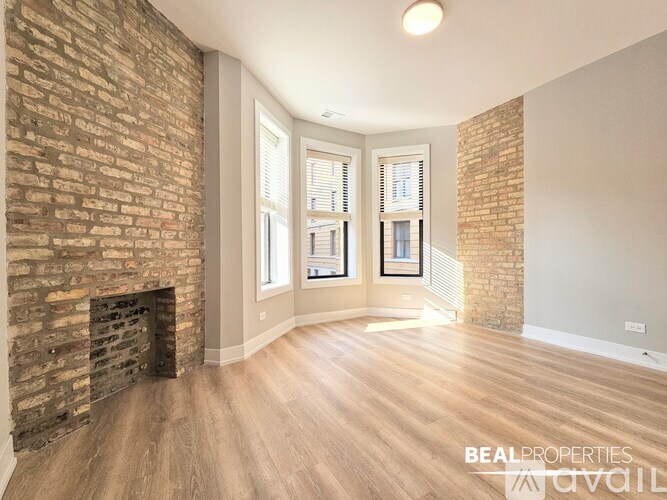 A room with a brick wall and wooden flooring.