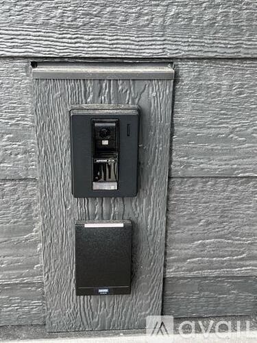 A black electrical outlet with a black box below it.