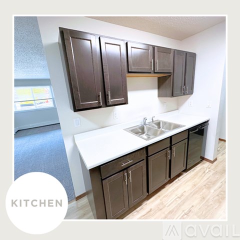 A kitchen with brown cabinets and a white countertop.