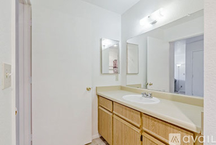A bathroom with a sink and mirror.