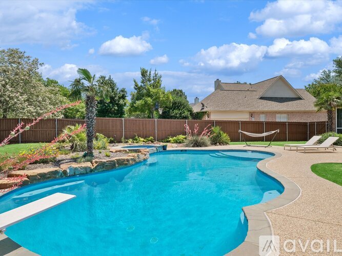 A swimming pool in a backyard with a house in the background.