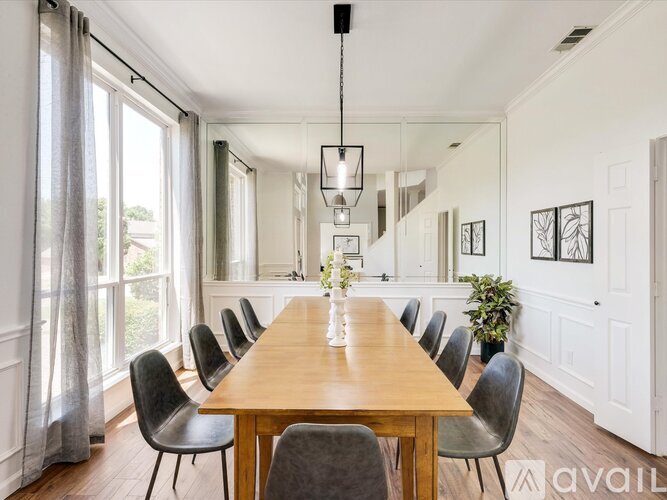 A dining room with a long table and chairs.