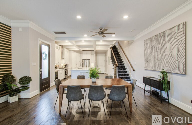 A bedroom with a bed, two lamps, and a painting on the wall.