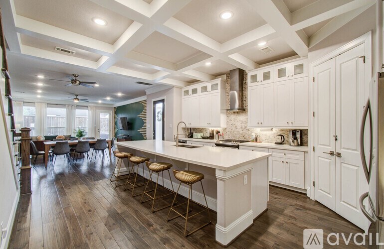 A bedroom with a bed, chair, and a fan.