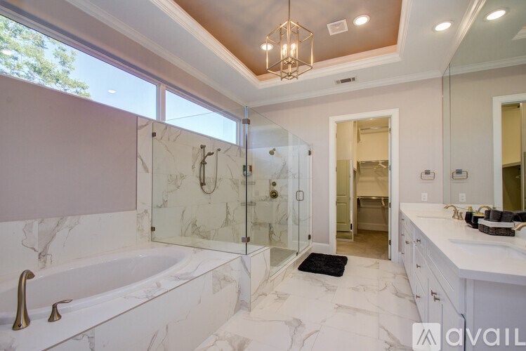 A bathroom with a marble tub and sink.