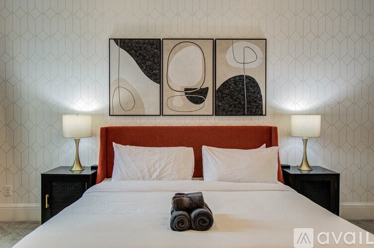 A bedroom with a bed, desk, and chair.