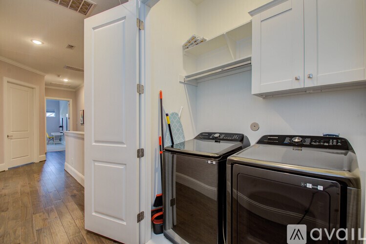 A kitchen with a white door open to a hallway.