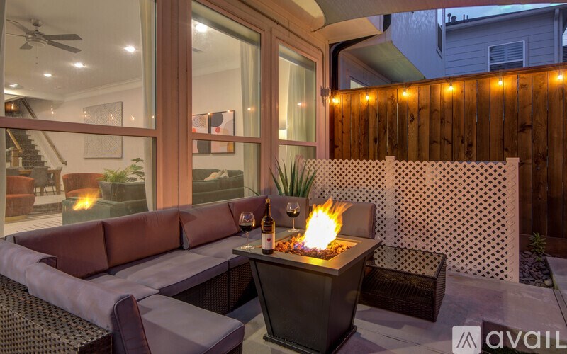 A patio with a fire pit and a couch.