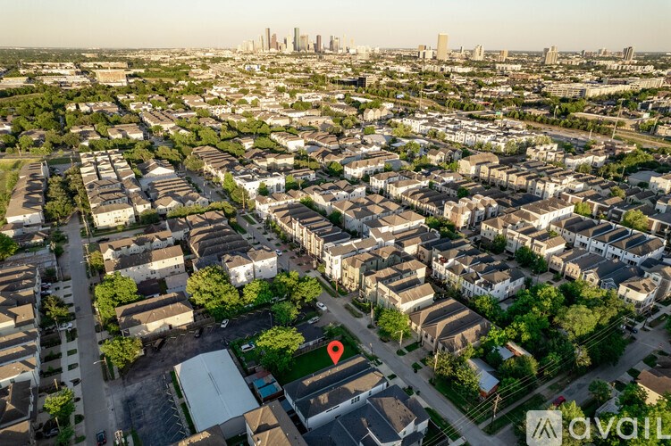 A bird's eye view of a residential area with apartment buildings and greenery.