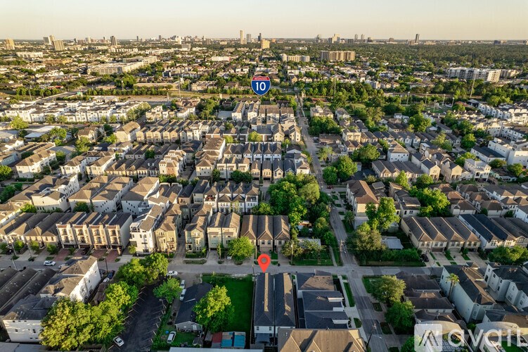 An aerial view of a city with a red circle and a white line in the middle of the street.