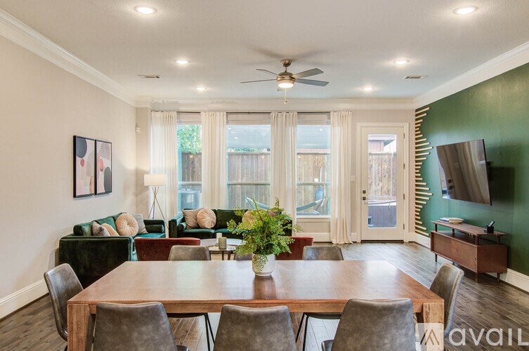A kitchen with white cabinets and a darker counter top.