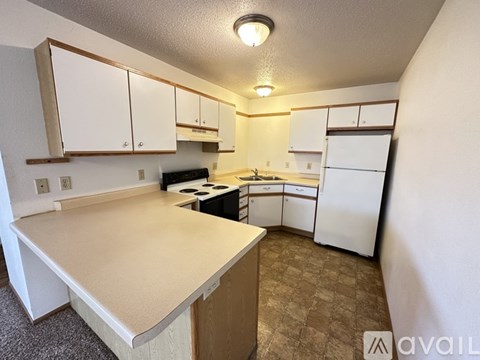 A kitchen with white cabinets and a countertop.