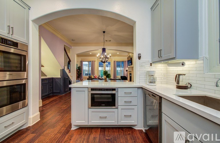 A bathroom with a walk-in shower and double sinks.