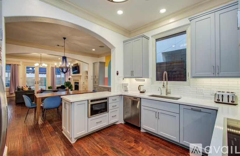 A bedroom with a bed, nightstand, and a ceiling fan.