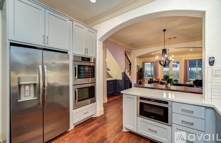 A bathroom with a sink, mirror, and a white door.