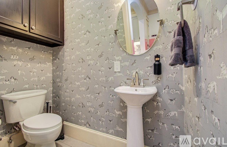 A bathroom with a glass shower door and a granite countertop.
