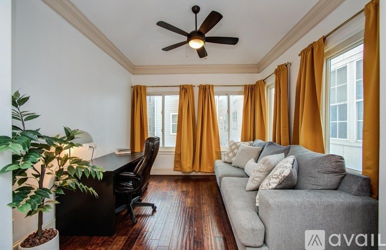 A laundry room with a washer and dryer, a counter, and cabinets.