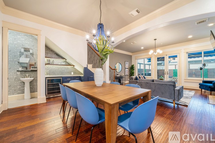 A dining room with a wooden table and blue chairs.
