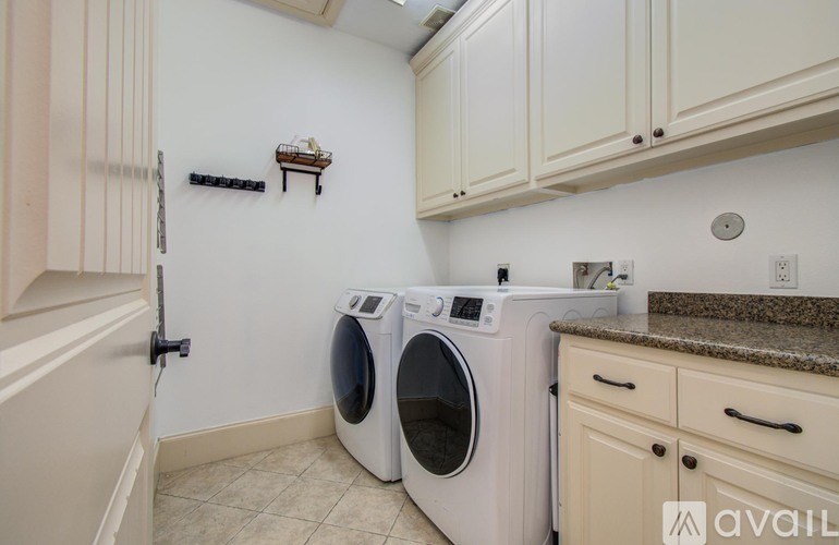 A laundry room with a washer and dryer.