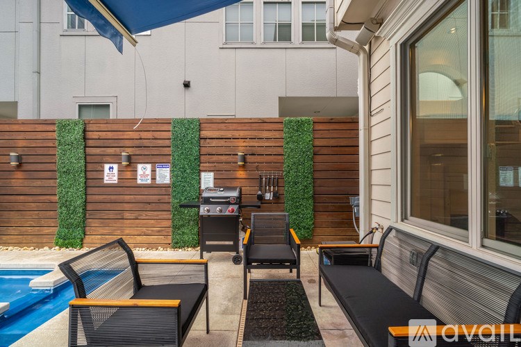 A poolside area with a black chair and a table.