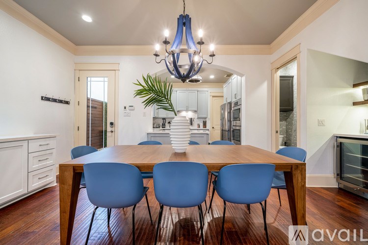 A dining room with a wooden table and blue chairs.