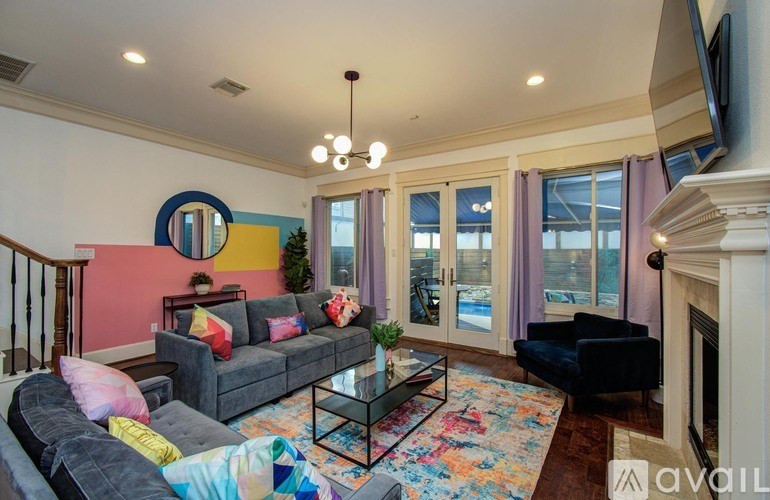 A modern kitchen with wooden floors and white cabinets.