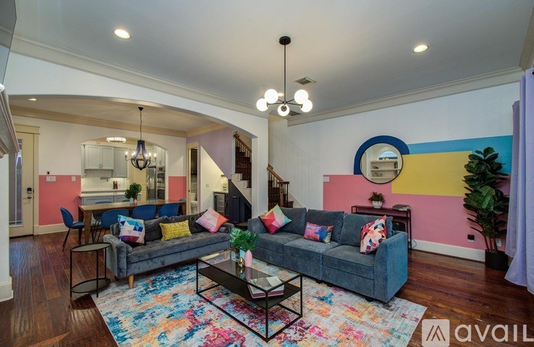 A modern kitchen with stainless steel appliances and wooden floors.