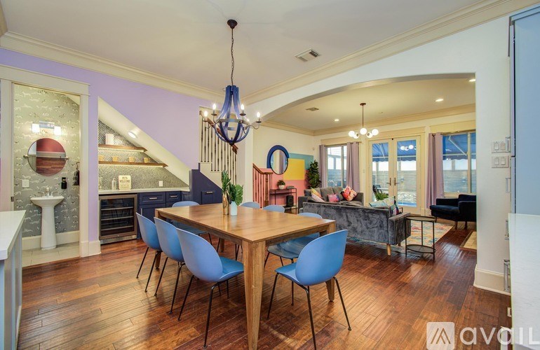 A kitchen with white cabinets and a marble countertop.